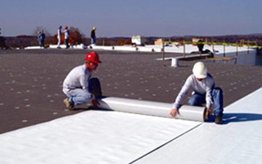 workers putting on roofing rolls